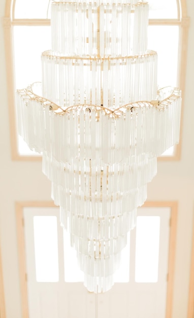 A chandelier hangs from the ceiling in a home.