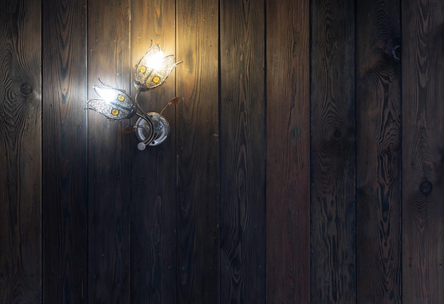 chandelier in the shape of a flower on a wooden wall