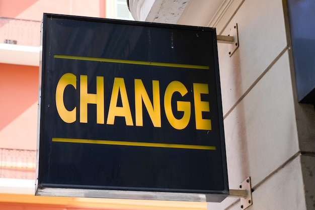 Change means in french text yellow exchange money office on\
wall entrance facade