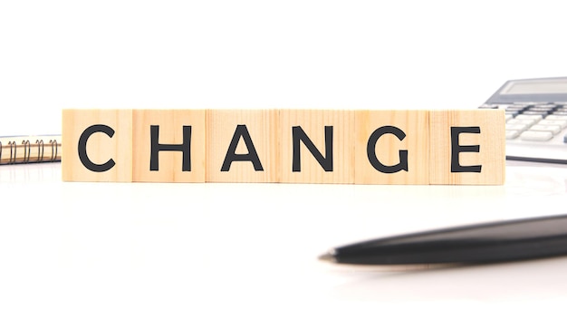 Premium Photo | Change word word assembled from wooden cubes next to a