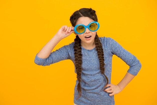 Change your body language small girl has funny look kid hairstyle fashion amazed child with hairdo teen has party fun Hair braided in braids little beauty wear party glasses happy childhood