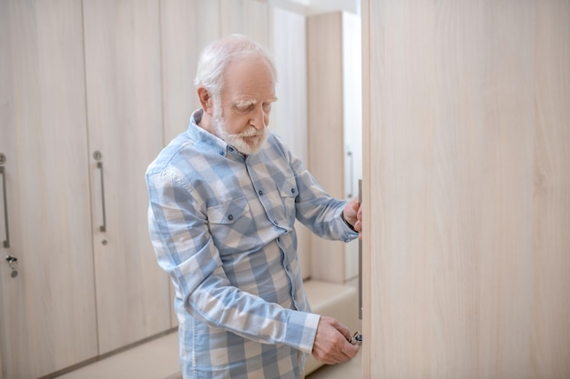 Changing room. gray-haired mature man in a changing room in spa
center