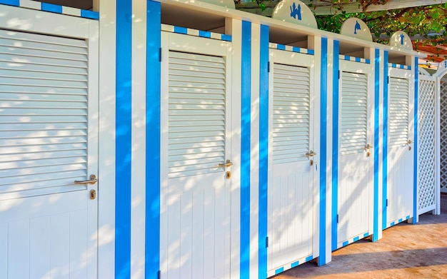 Changing rooms at the beach at coastal positano town on rocks on amalfi coast and tyrrhenian sea in italy in summer. view of amalfitana coastline with architecture near salerno