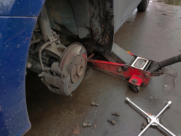 Changing a wheel on a car jack at a car service station