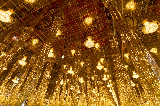 Chantaram Temple or Tha Sung Temple, Beautiful Golden Buddha statue inside Wihan Kaeo or glass sanctuary, Famous place in UTHAI THANI, THAILAND.