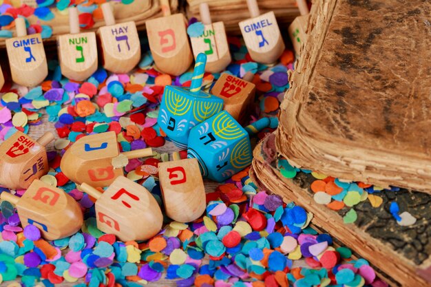 Chanukah wooden dreidels on a wood surface.