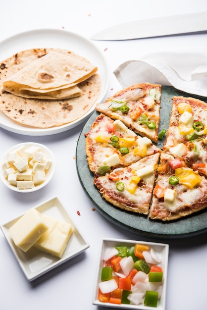 Chapati Pizza made using leftover Roti, Paratha with Cheese, vegetables, paneer and Sausage