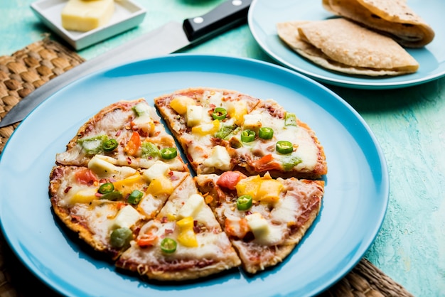 Chapati Pizza made using leftover Roti, Paratha with Cheese, vegetables, paneer and Sausage