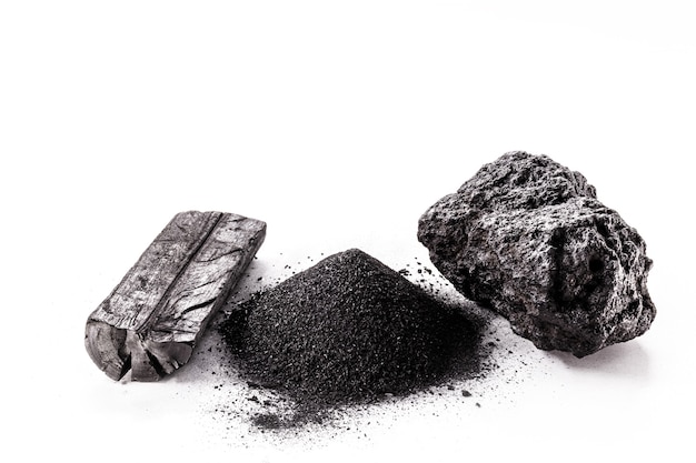 Charcoal, coal dust and mineral coal on isolated white surface.