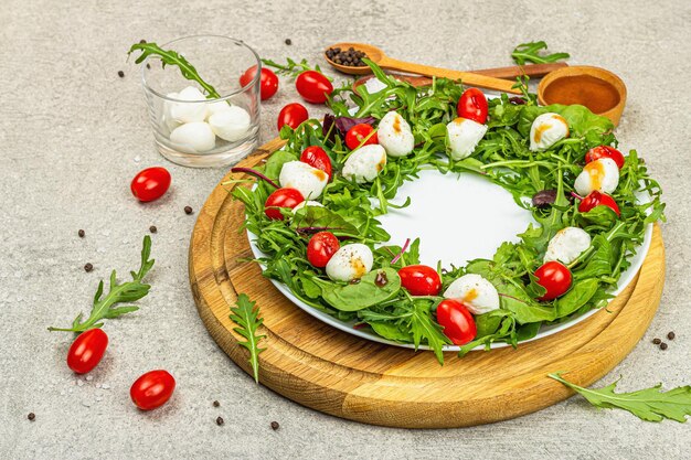 Charcuterie wreath made with mozzarella cherry tomato arugula Fashionable snack vegetarian food