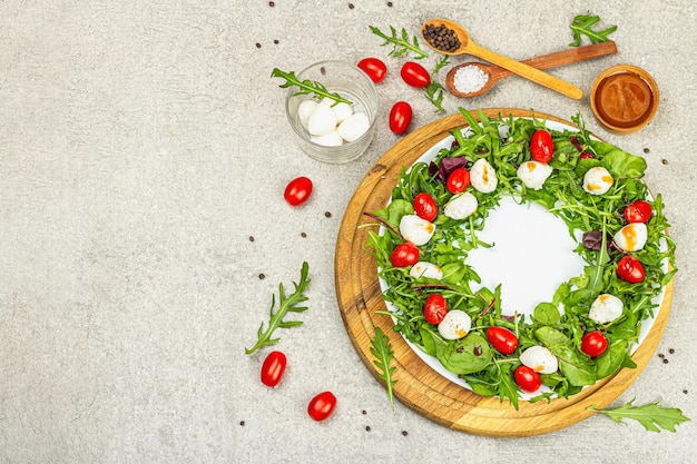 Charcuterie wreath made with mozzarella cherry tomato arugula Fashionable snack vegetarian food