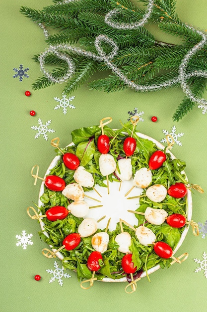 Charcuterie wreath in traditional New Year color design with Christmas decorations Modern snack