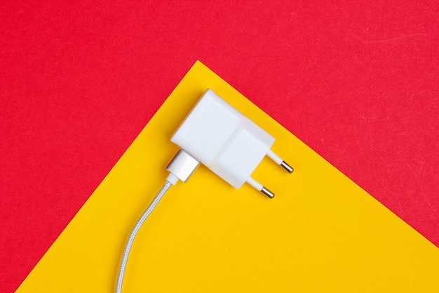 Charger with cable on red-yellow