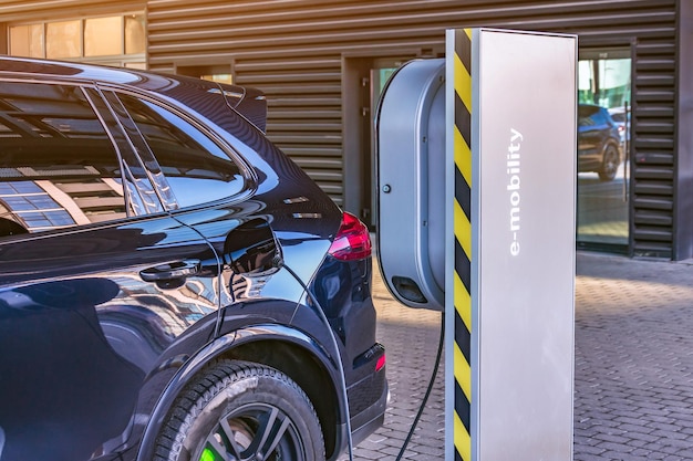 Charging an electric car at a car repair shop service garage. Refueling for electric cars e-mobility.