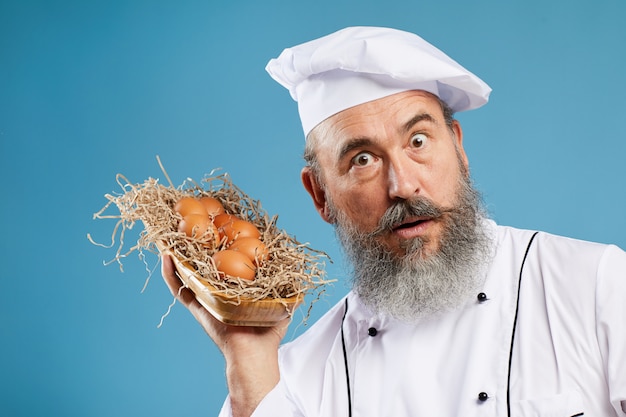 Charismatic Bearded Chef Holding Eggs