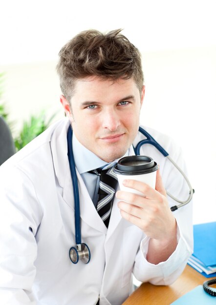 Charismatic doctor having a break in the staff room 