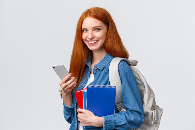 Charismatic friendly-looking european redhead female university student