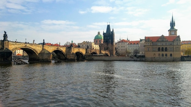 Charles bridge over river vltava with buildings in background