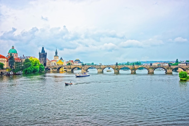 Charles Bridge over Vltava River, Prague, Czech Republic. Old Town Bridge Tower and Church of Knights of the Cross on the background