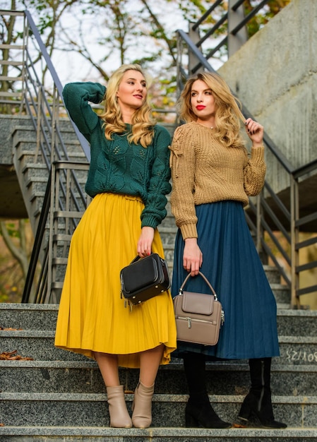 Charm stylish autumn women outdoor girl friends go upstairs fall season color trends Pleated trend girls in corrugated skirt and sweater female beauty knitwear fashion for youth