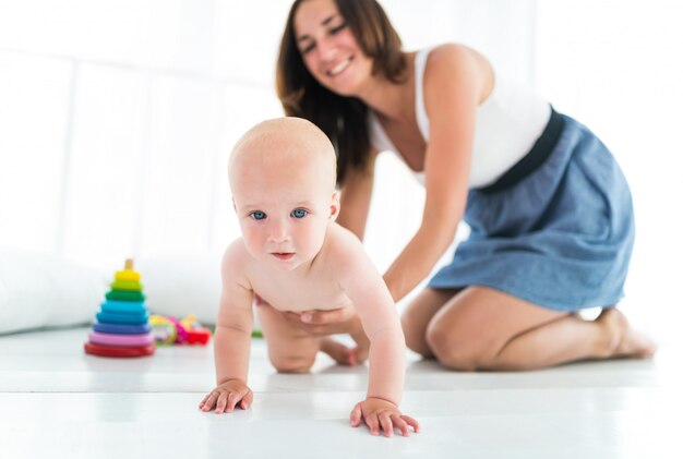 Charmante jonge moeder roept naar haar kleine baby