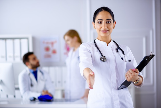 Charming arab doctor handshake with a patient