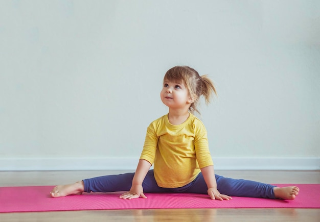 Charming baby sits in leg-split. Place for text