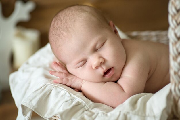 Charming baby sleeping wicker stroller closeup