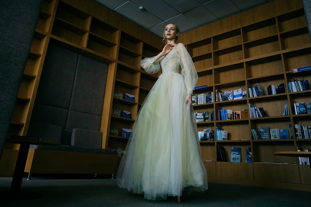 Charming ballerina went to the library to choose a new book during a break showing your stretching and flexibility