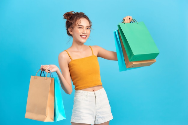 Charming beautiful Asian confident woman show shopping bags.