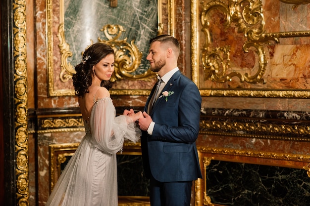 Charming bride and groom on their wedding celebration in a luxurious studio, hotel and restaurant.