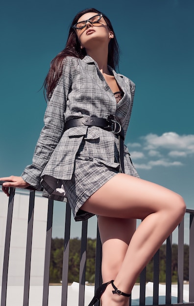 Charming bright brunette wearing woolen checkered business suit