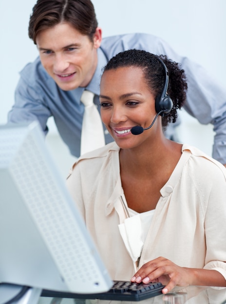 Charming business people working at a computer 