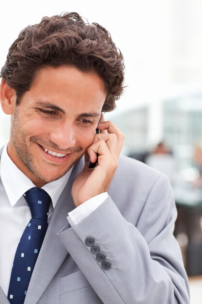 Charming businessman phoning in his office