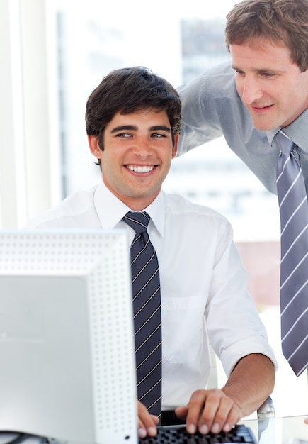 Charming businessman working at a computer with his manager