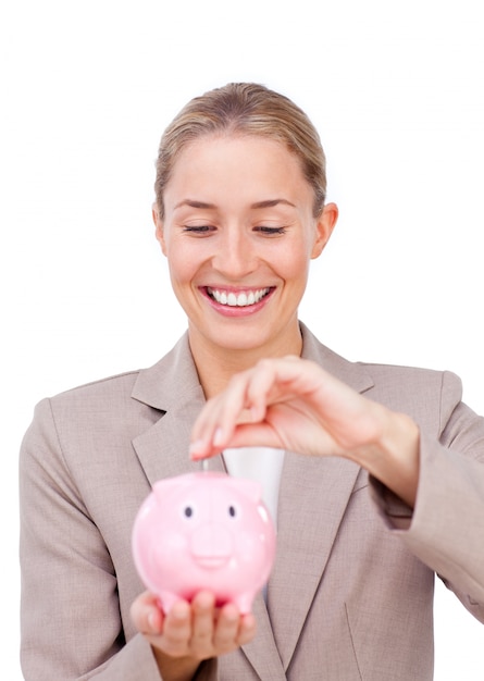 Charming businesswoman saving money in a piggybank 