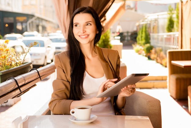 Charming businesswoman sitting in a cafe