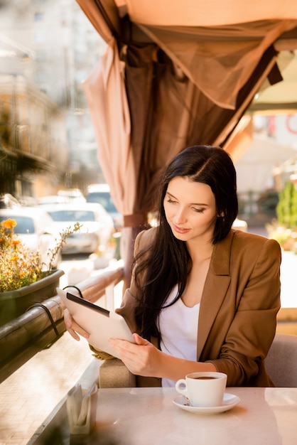 Charming businesswoman sitting in a cafe