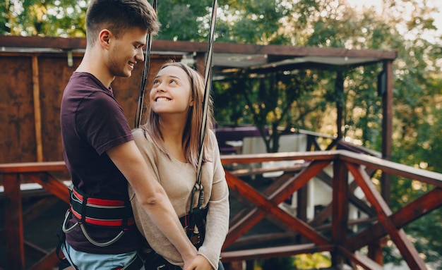 A charming caucasian lady looking for confidence in her lover's eyes is holding his hand and smiling innocently