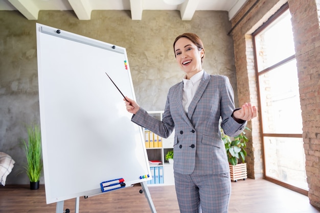 charming confident businesswoman hold pointer teach lesson indoors