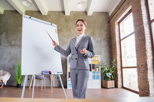 charming confident businesswoman hold pointer teach lesson indoors