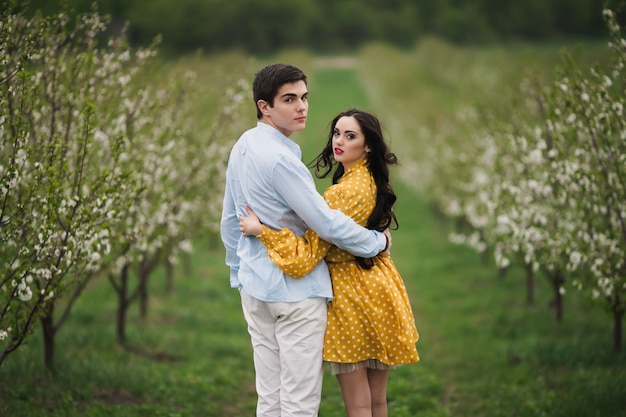 Charming couple walking in orchard