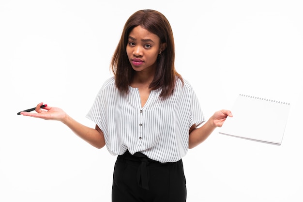 charming dark-skinned young girl explain smth on the plane table isolated on background