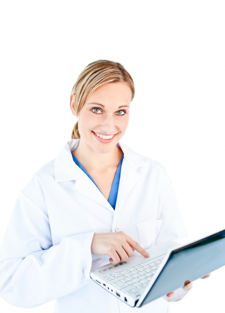 Charming female doctor holding a laptop looking at the camera