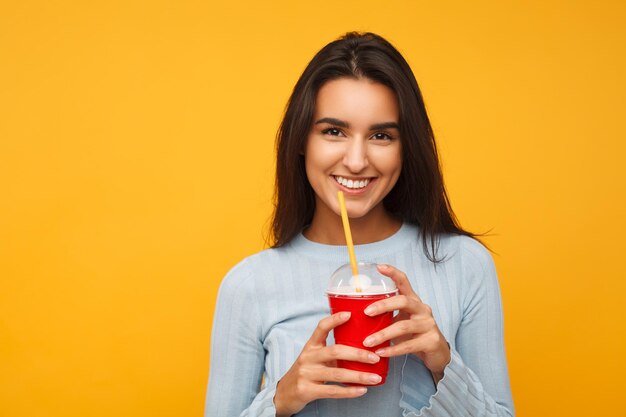 Charming girl having cup of drink