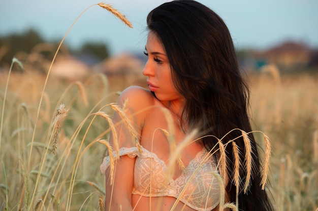 A charming girl walks around the field in her underwear