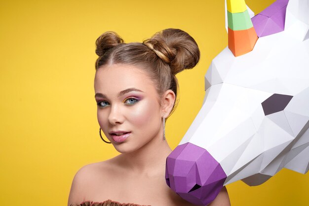 Charming girl with bright makeup looking at camera