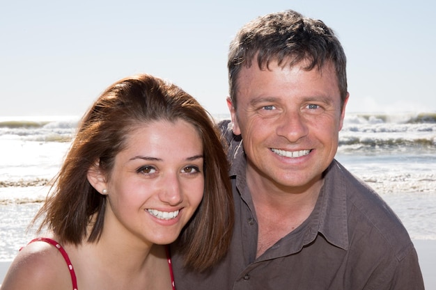 Charming and handsome couple holding one another at the beach