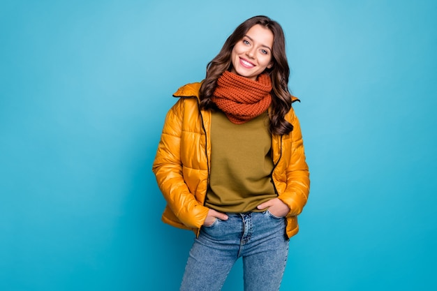 Charming lady holding hands into pockets isolated