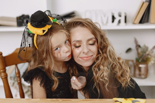 Charming little girl hugs her pretty mother so lovingly